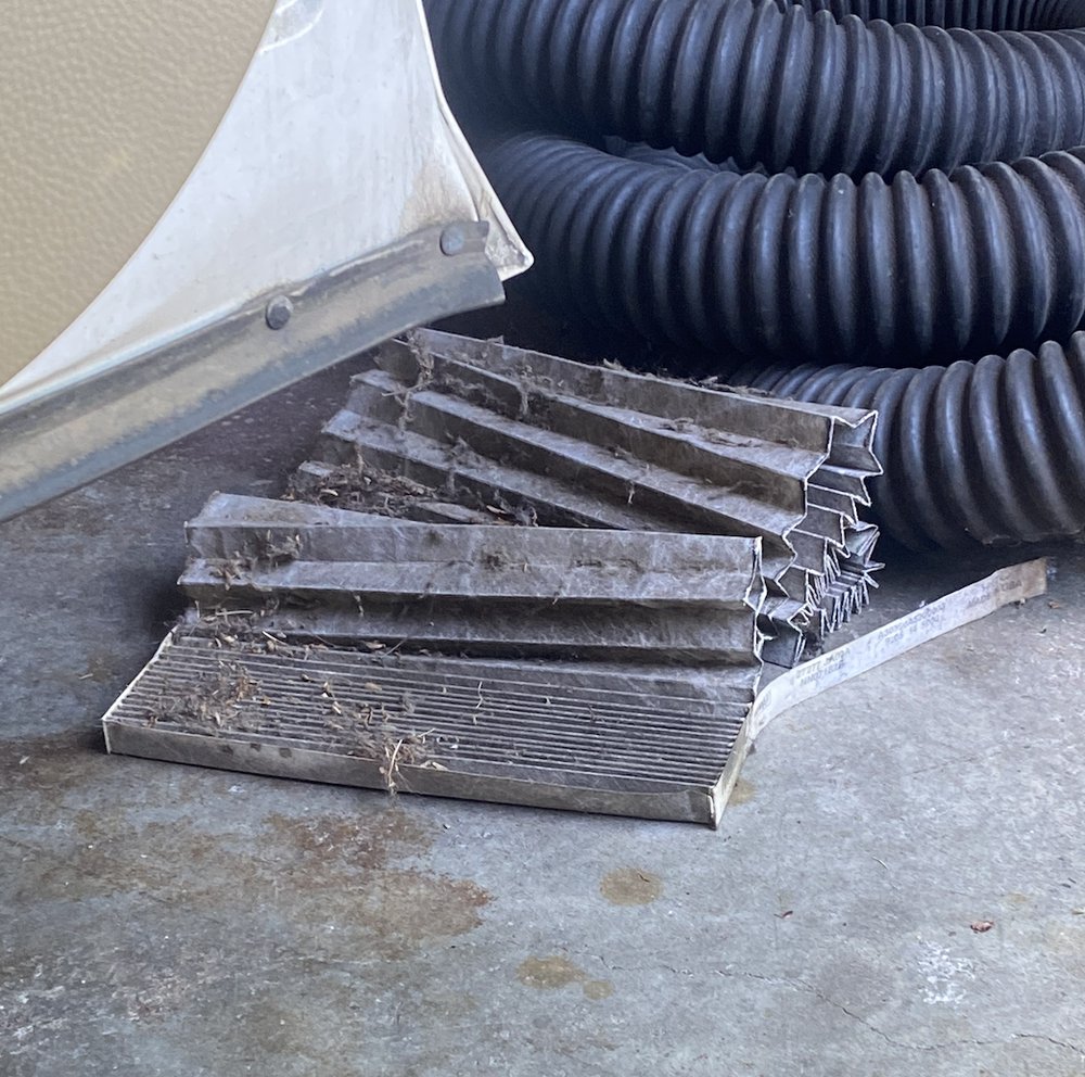 Vehicle part and shop hose photographed in a service-center setting
